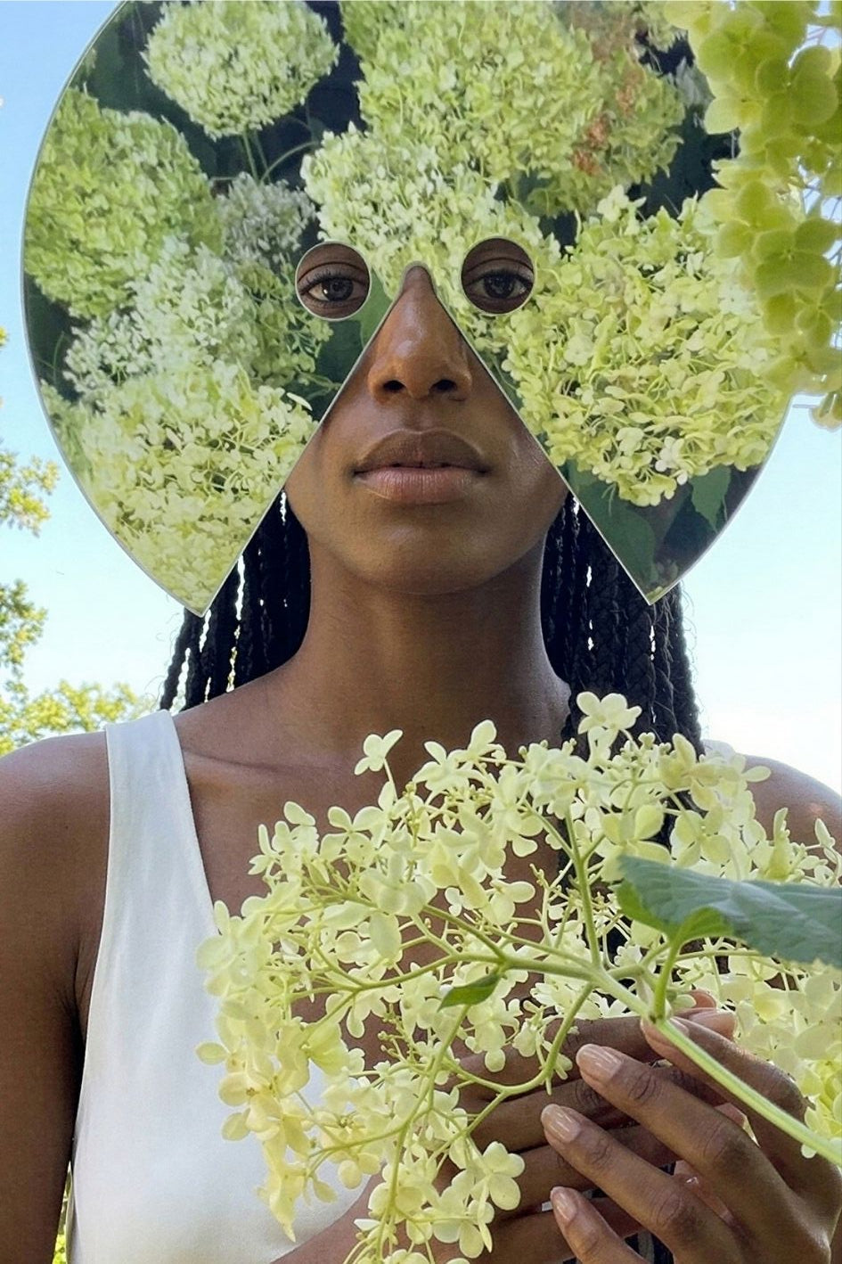Woman in nature with flowers – From Natural Origin to Synthetic Norm